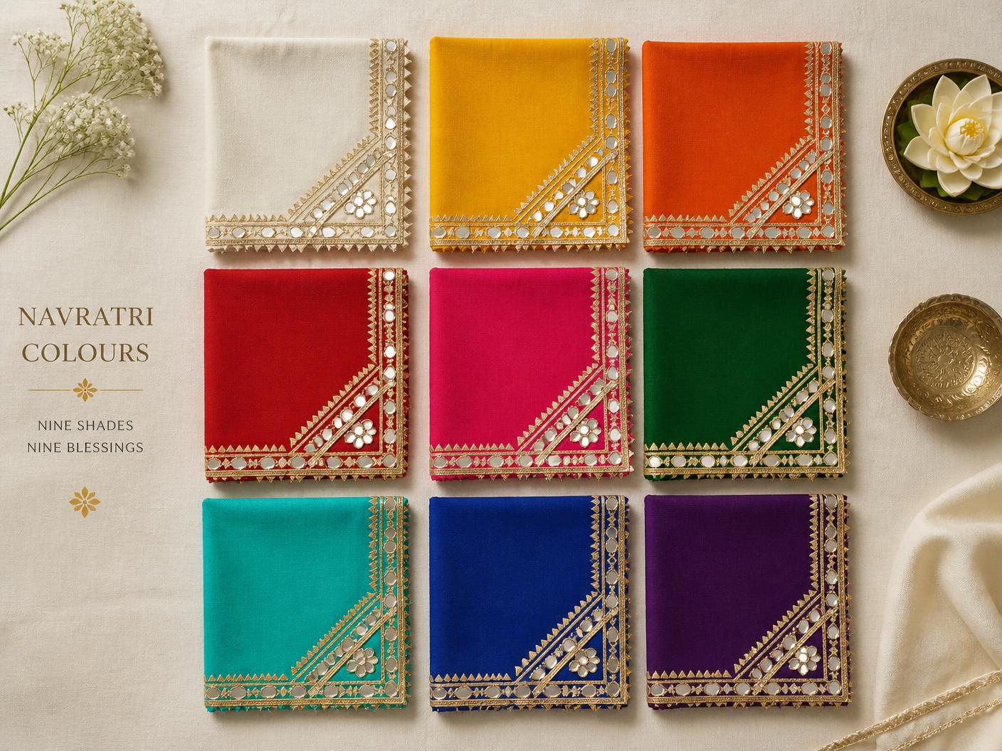Nine Navratri colour fabric swatches with gold gota borders arranged on ivory linen